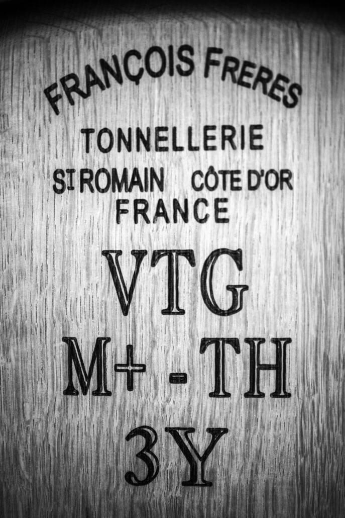 Close-up of text on a wooden barrel reading: "FRANÇOIS FRERES TONNELLERIE ST ROMAIN CÔTE D’OR FRANCE VTG M+ -TH 3Y.