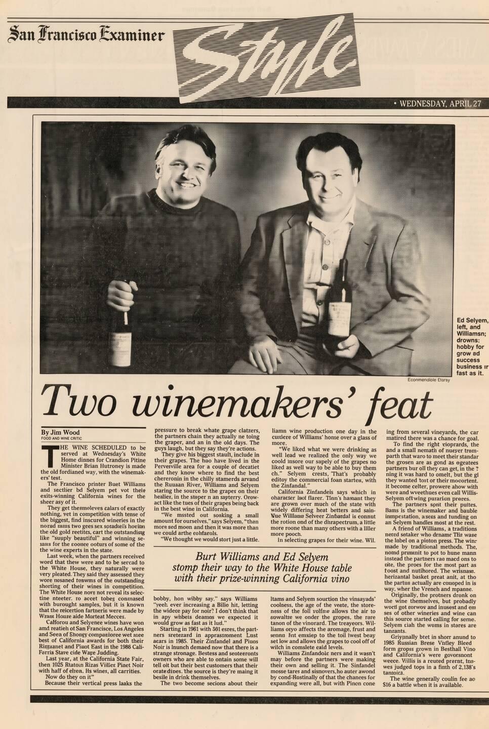Two men stand side by side, each holding a wine bottle and smiling, in a newspaper feature titled "Two winemakers' feat" from the San Francisco Examiner.
